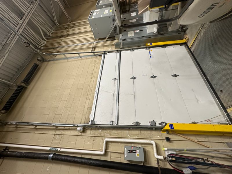 Large commercial sectional door with dual overhead openers and track system — Massachusetts